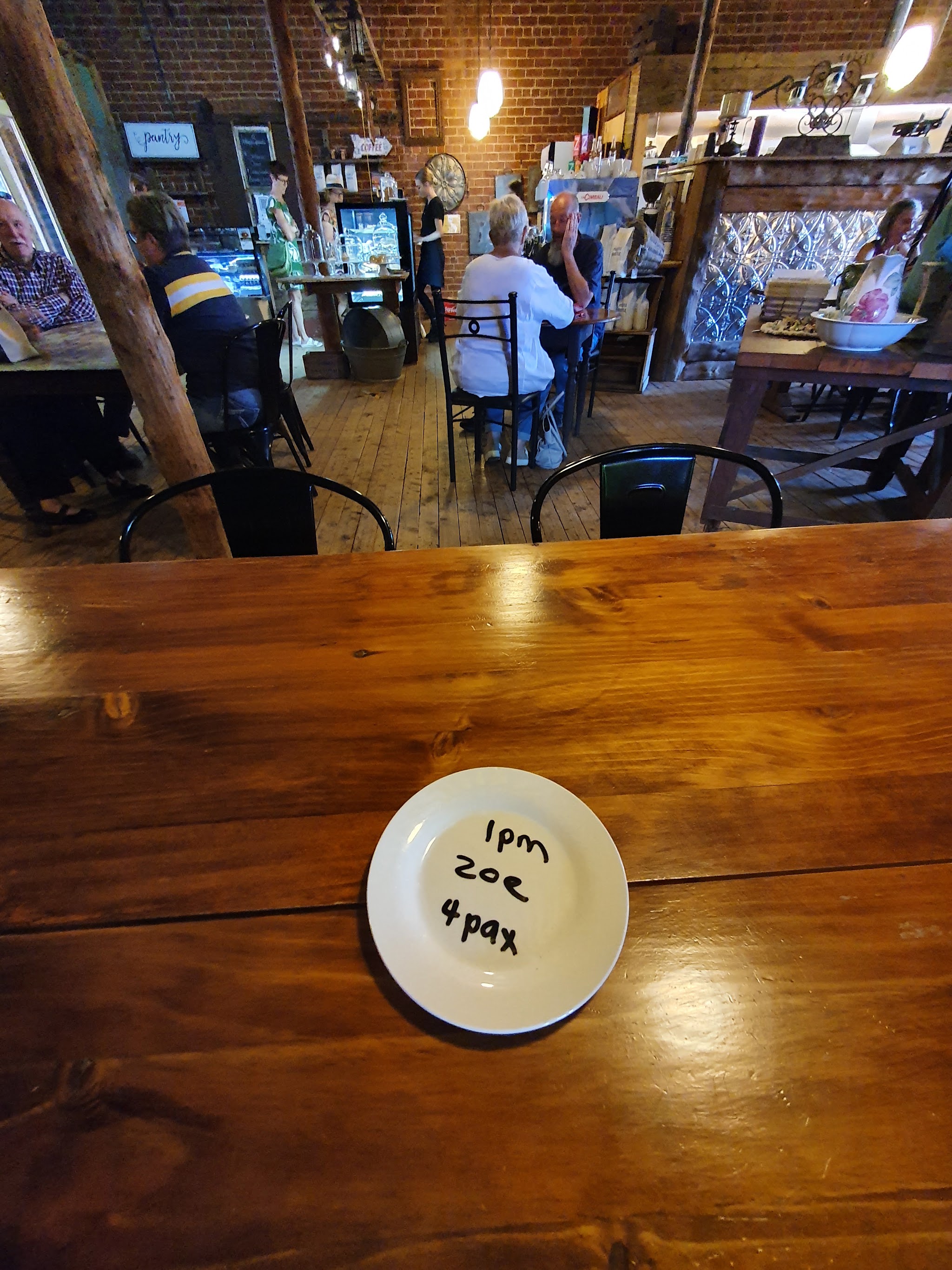 Customers in the dining room near the brick-walled counter