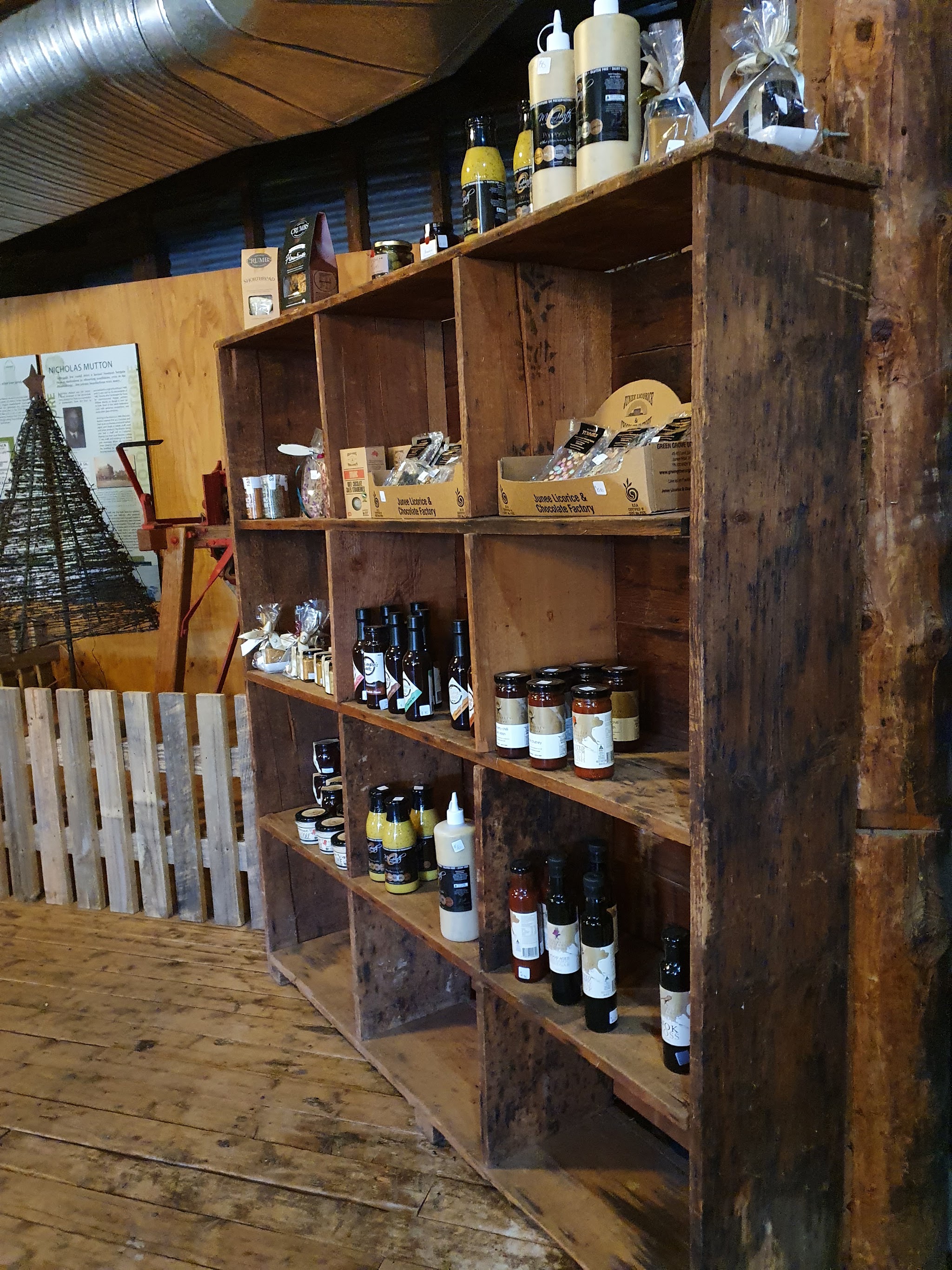 Timber crate shelving stocked with jams, chutneys, oils, mustards, licorice and shortbread